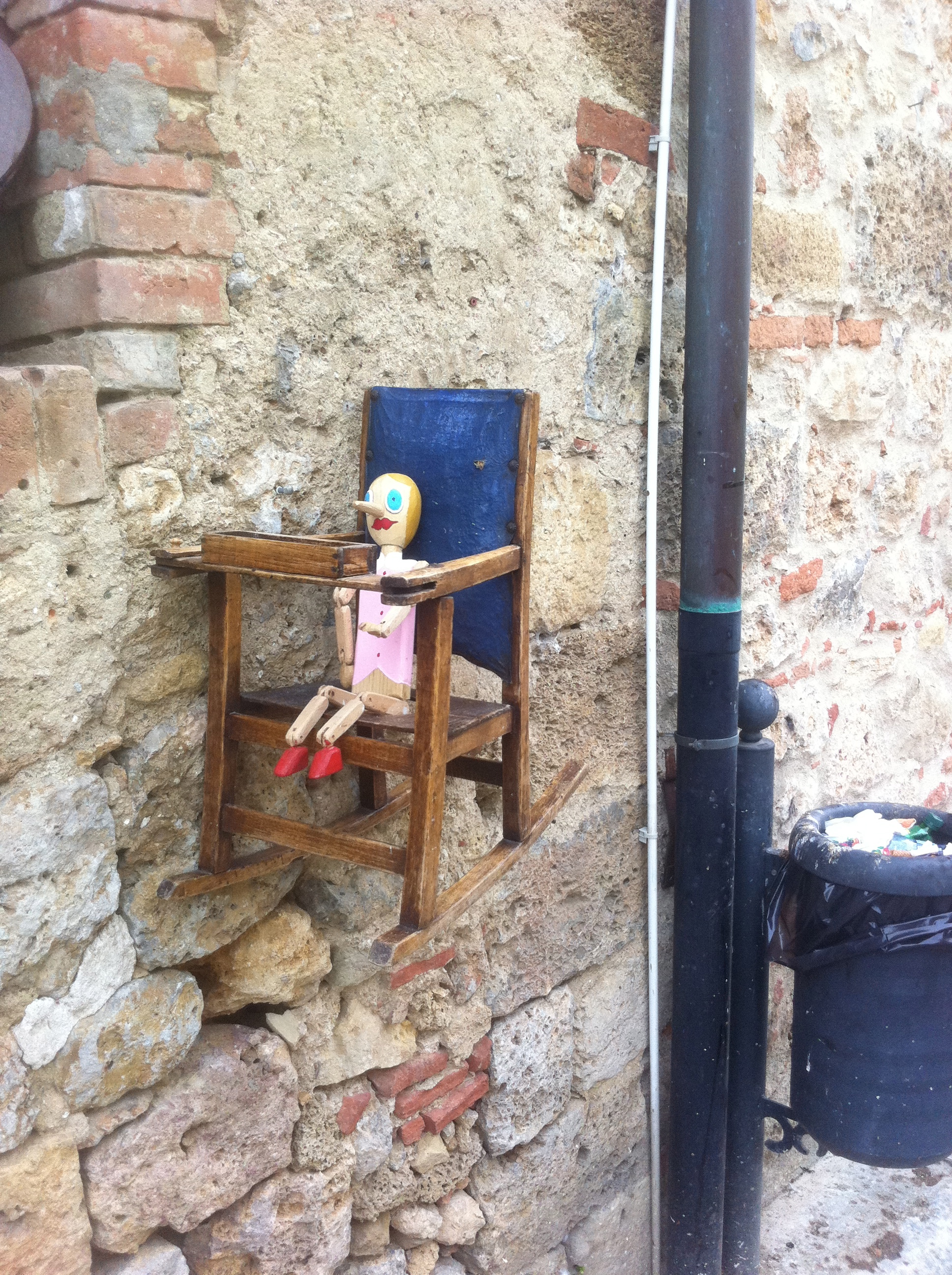 A beautiful medieval town with cobblestone, old shops, beautiful architecture, and this creepy thing. 